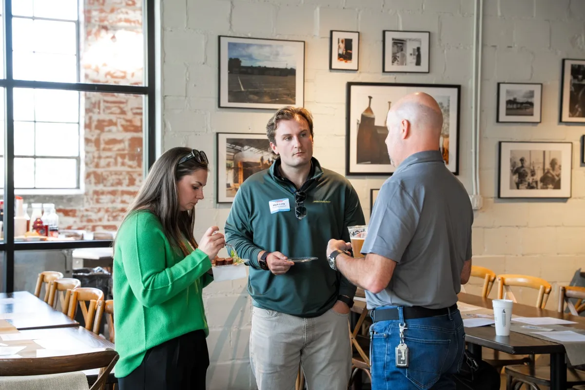 Attendees in conversation at the kickoff