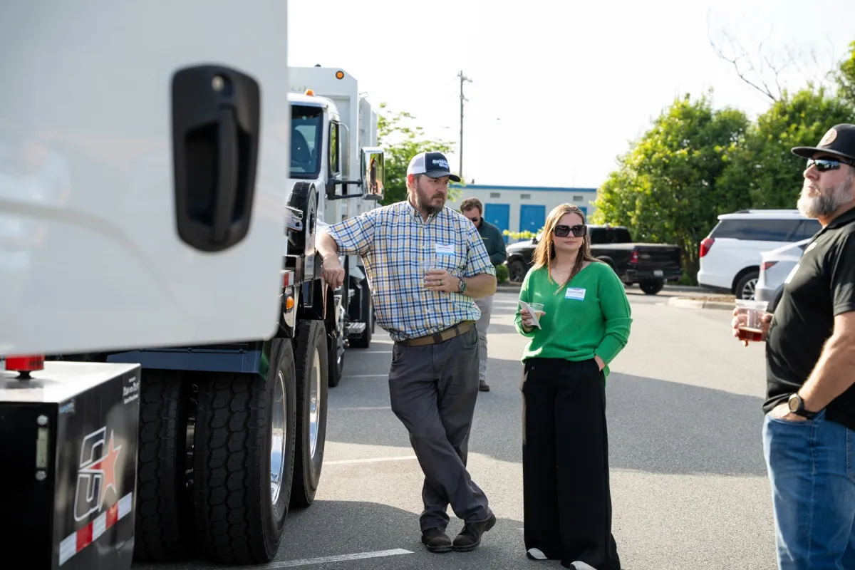 Independent haulers walking past trucks at the event