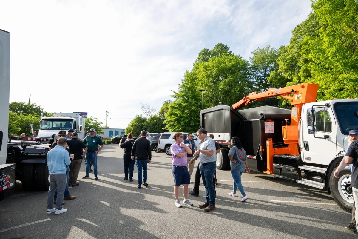 Trucks and attendees gathered in the parking lot