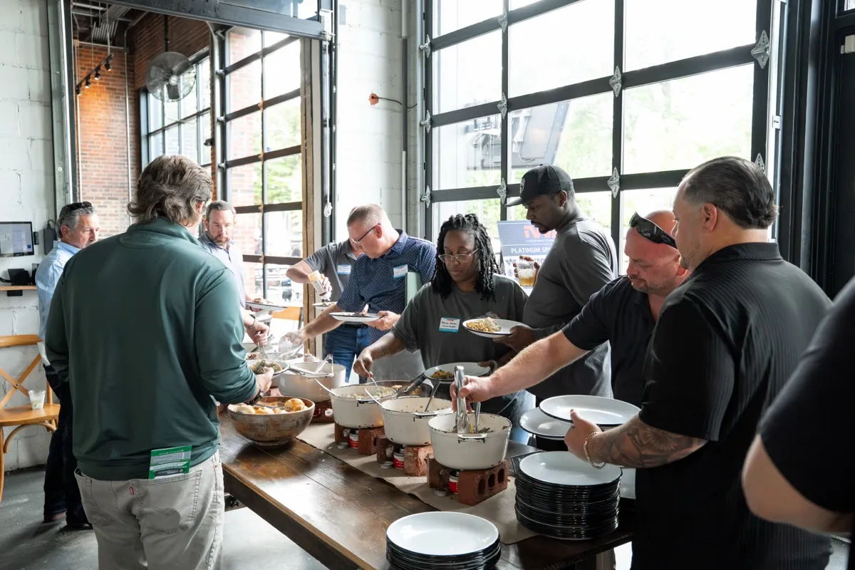 Attendees serving food at the kickoff lunch line