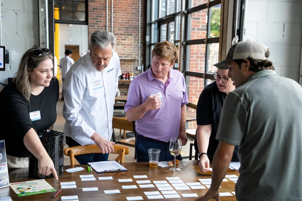 Members gathered around a table at the kickoff